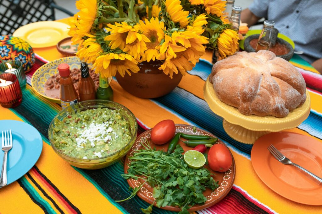 a variety of foods on the table near the sunflowers